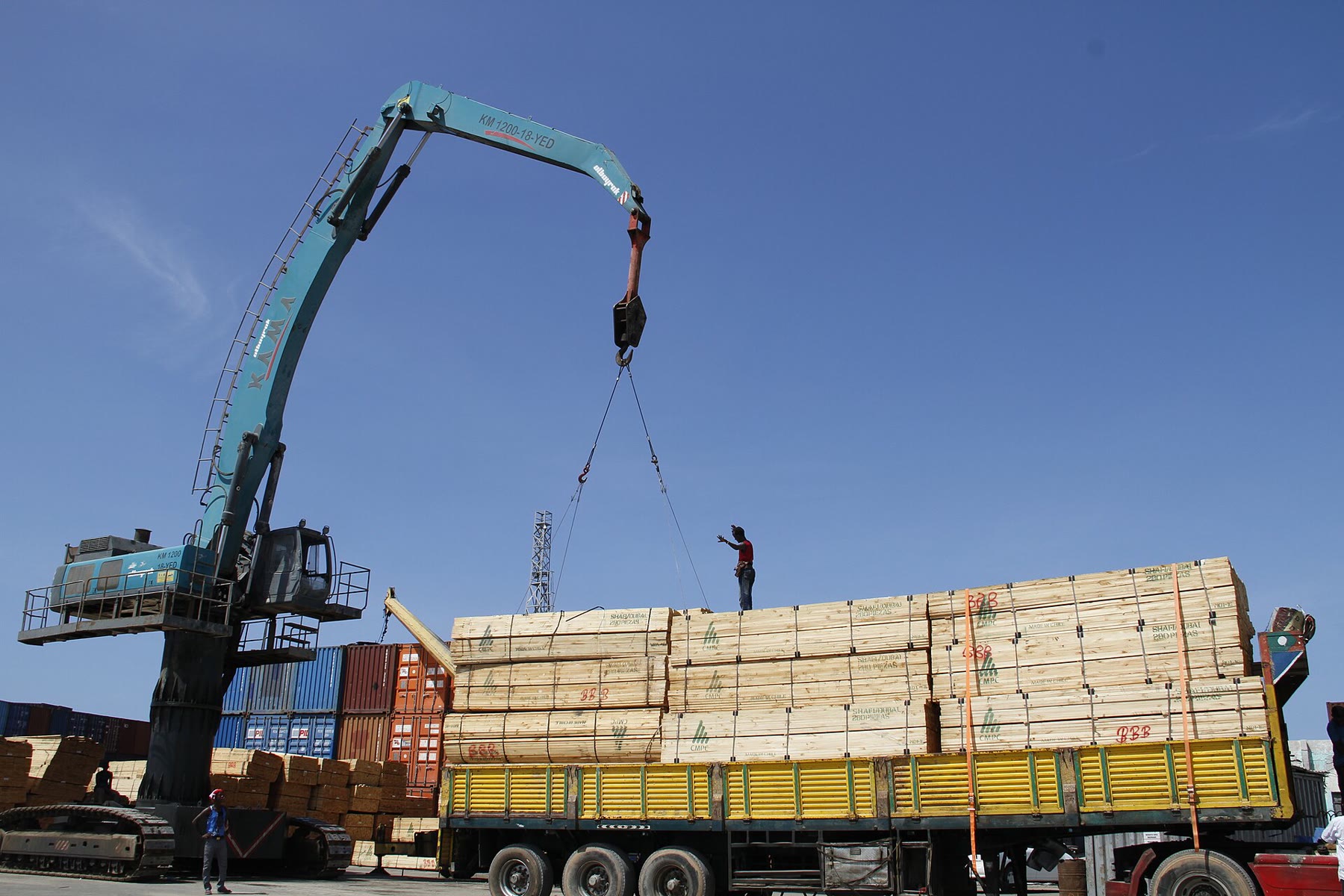 A crane loads sawn timber onto a lorry at Mogadishu sea port