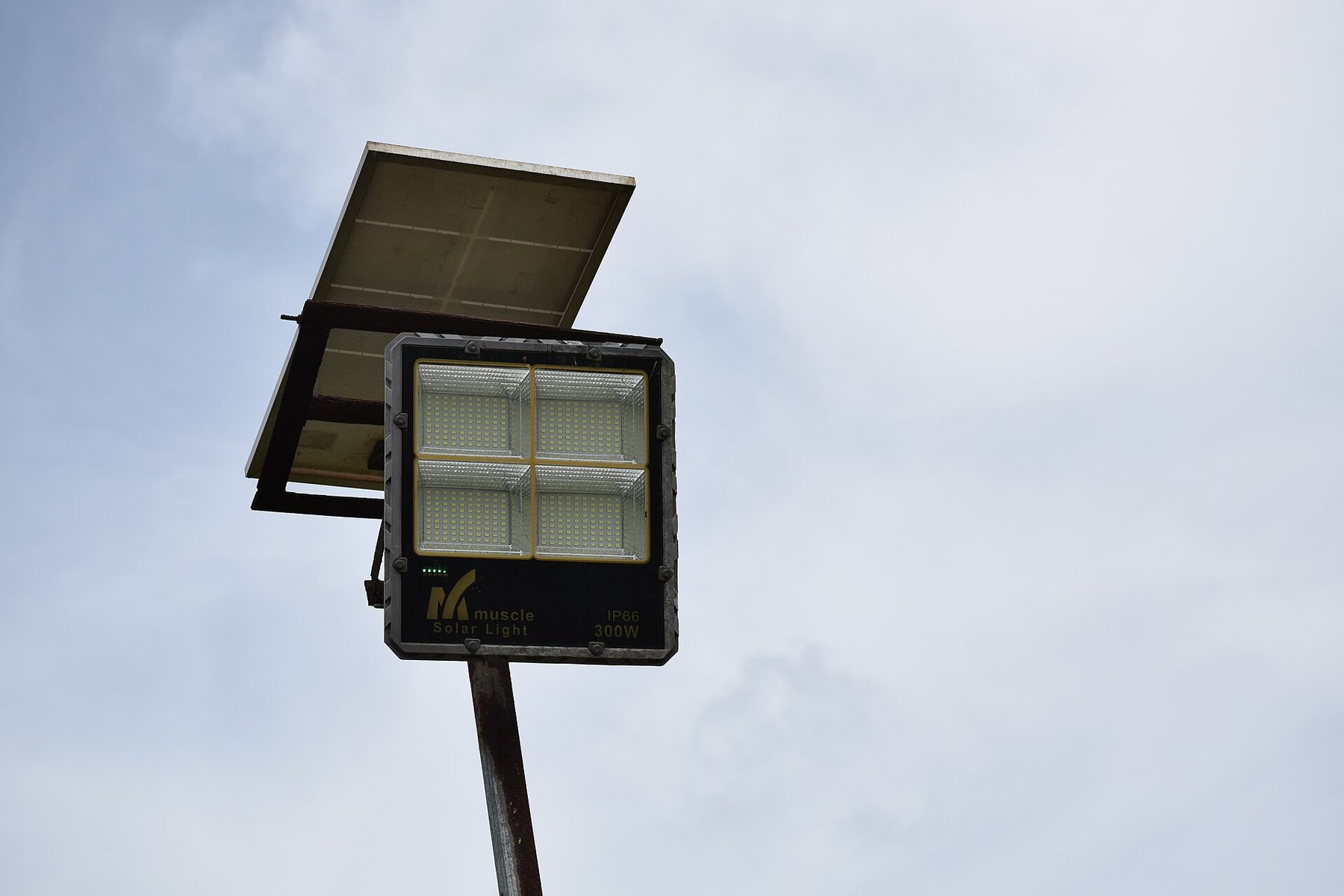 A solar street lamp standing over a village